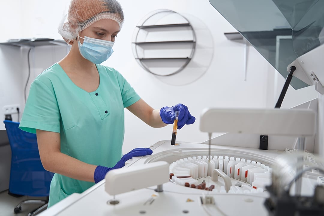 Medical professional preparing regenerative medicine treatment in a laboratory using advanced centrifuge technology